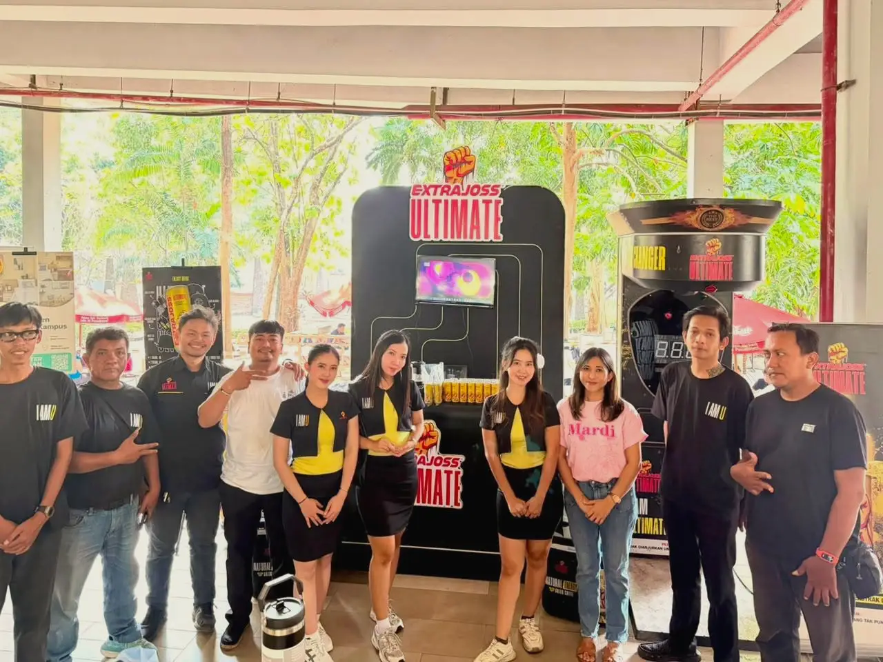 Three brand ambassadors in uniform with the activation crew beside a product display