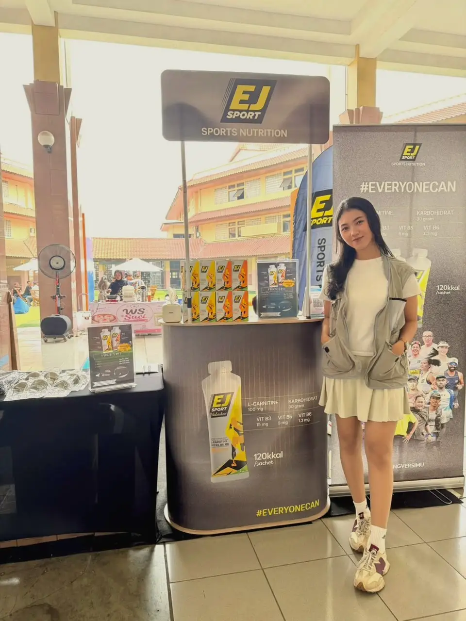 A brand ambassador standing beside a sports nutrition product counter